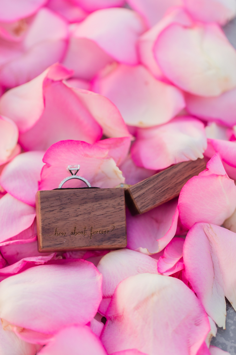 engagement ring pink roses flat lay