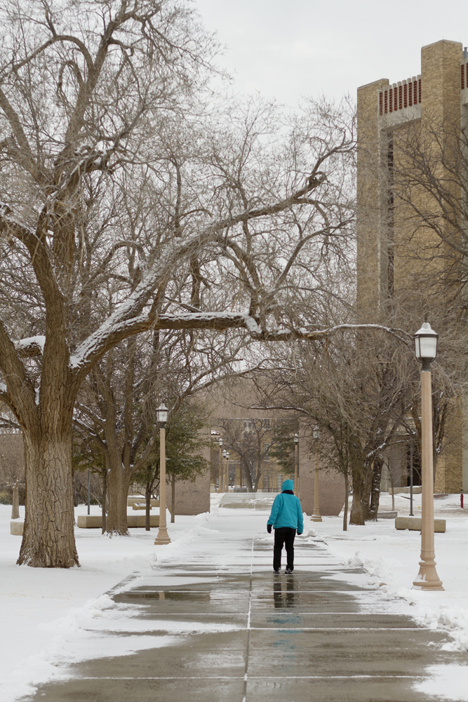 Janiha Gunatilake walks near the Biology building at Texas Tech's campus through the snow on Feb. 2, 2014.