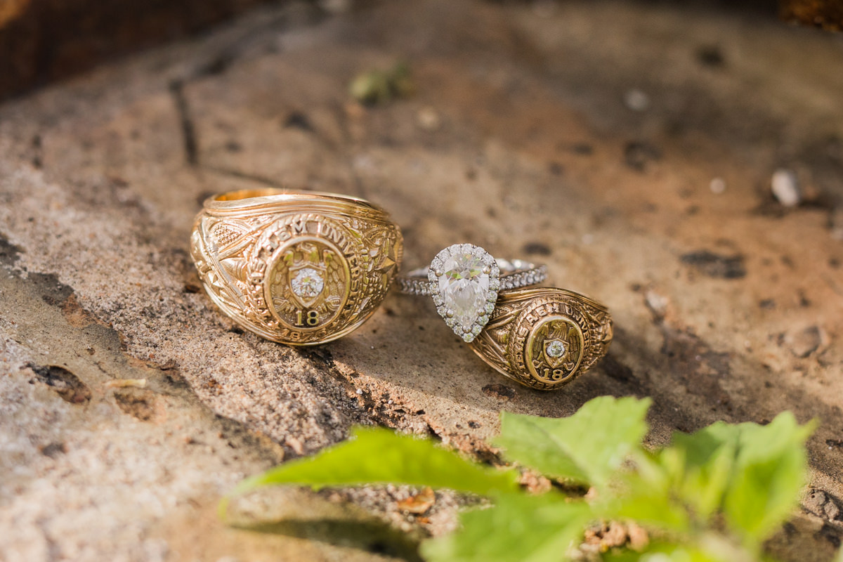 aggie class rings with engagement ring close up photo