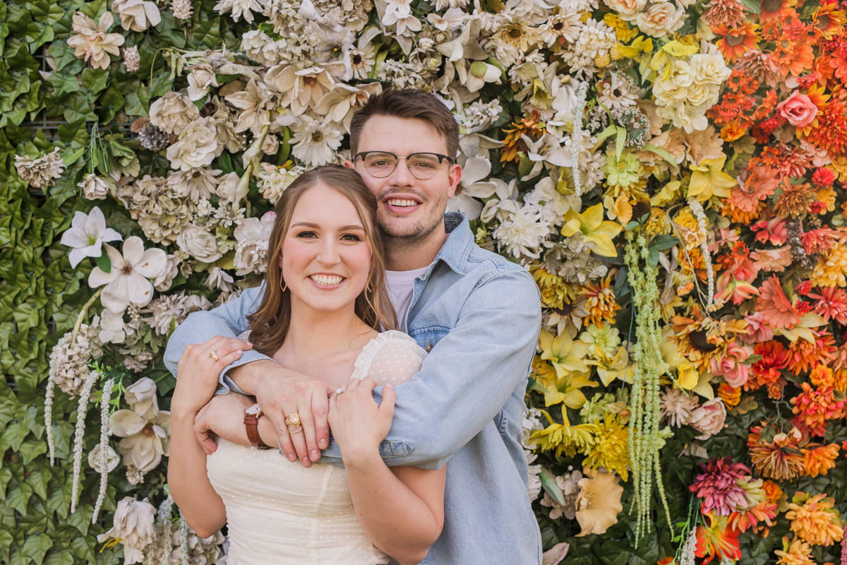 Sekrit Theater Greenhouse Engagement Photos, flower wall