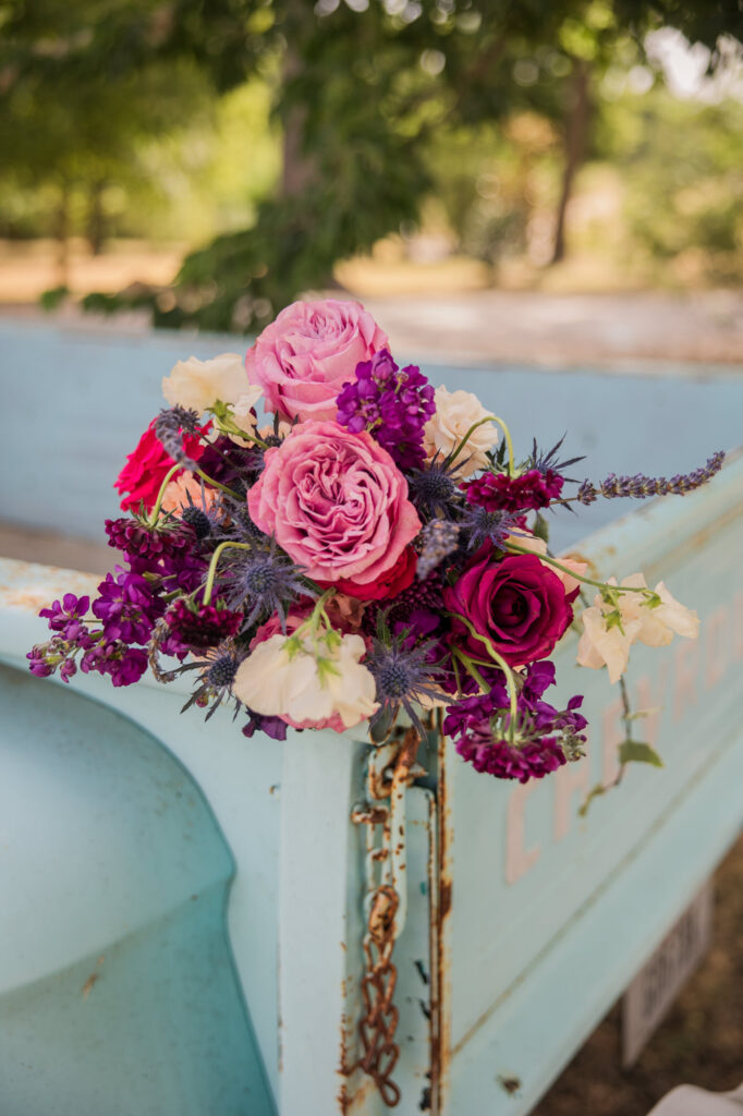 purple bridal bouquet on baby blue vintage pickup truck