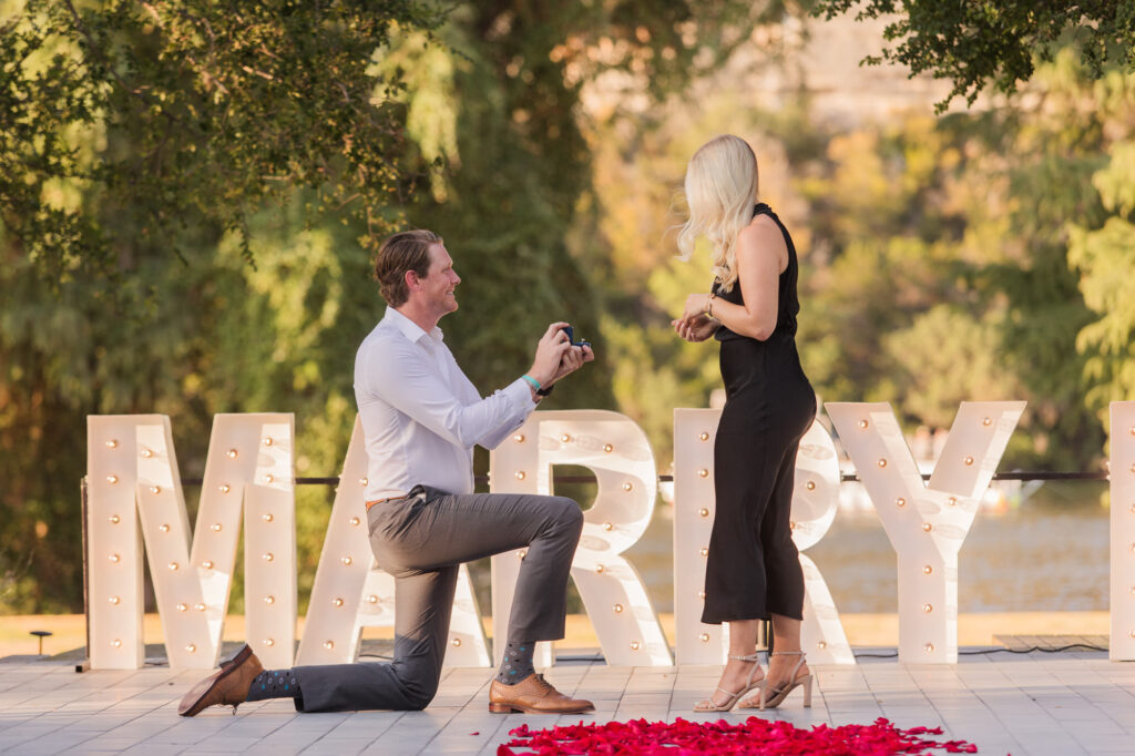 Romantic Proposal with Large Marry Me Sign