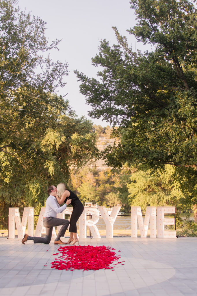 Romantic Proposal with Large Marry Me Sign