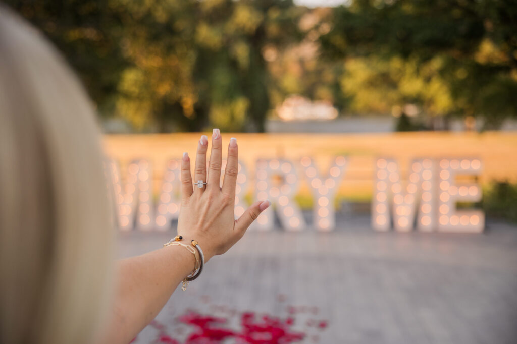 Romantic Proposal with Large Marry Me Sign