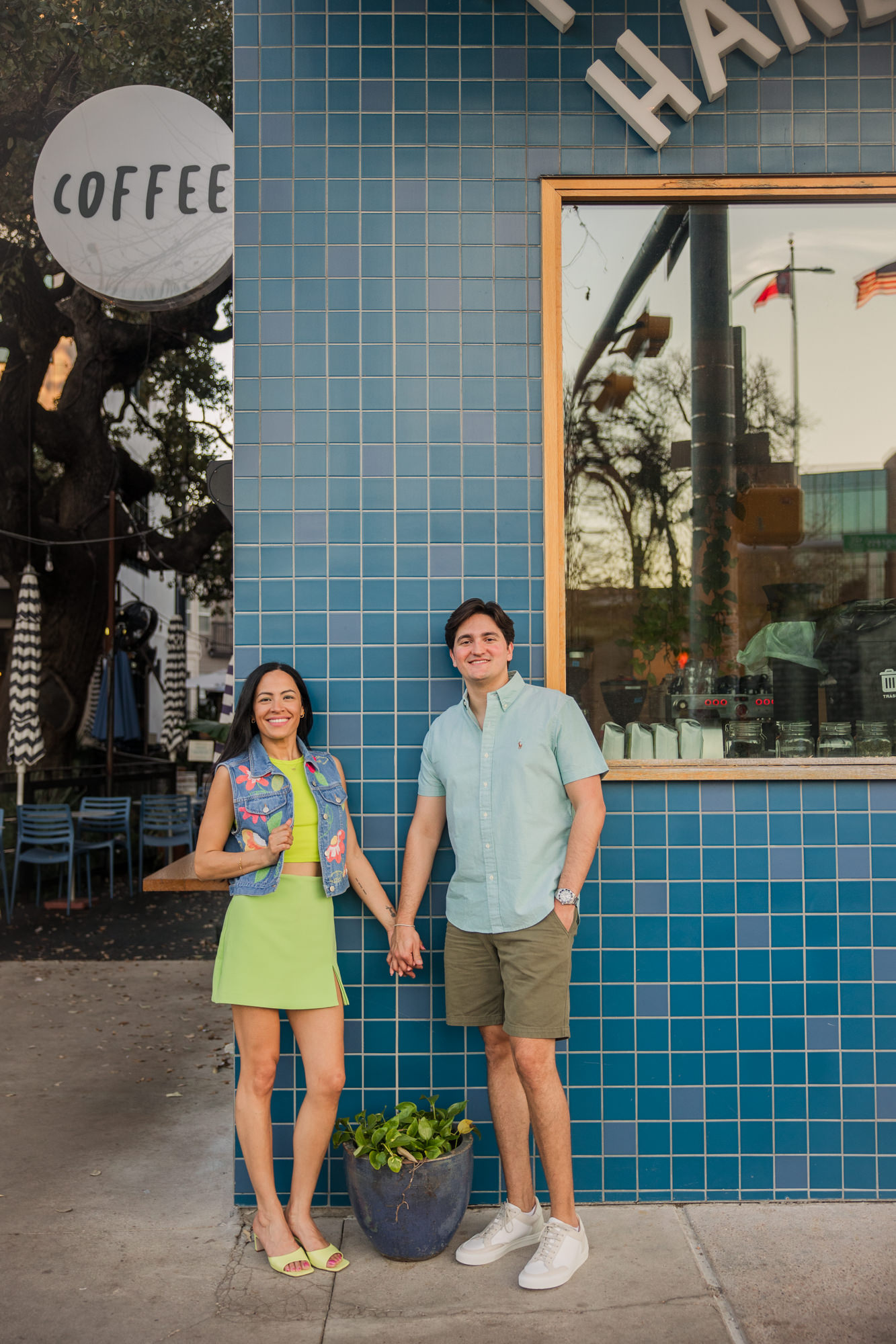 Colorful South Congress Engagement Photos | two hands coffee blue tile wall