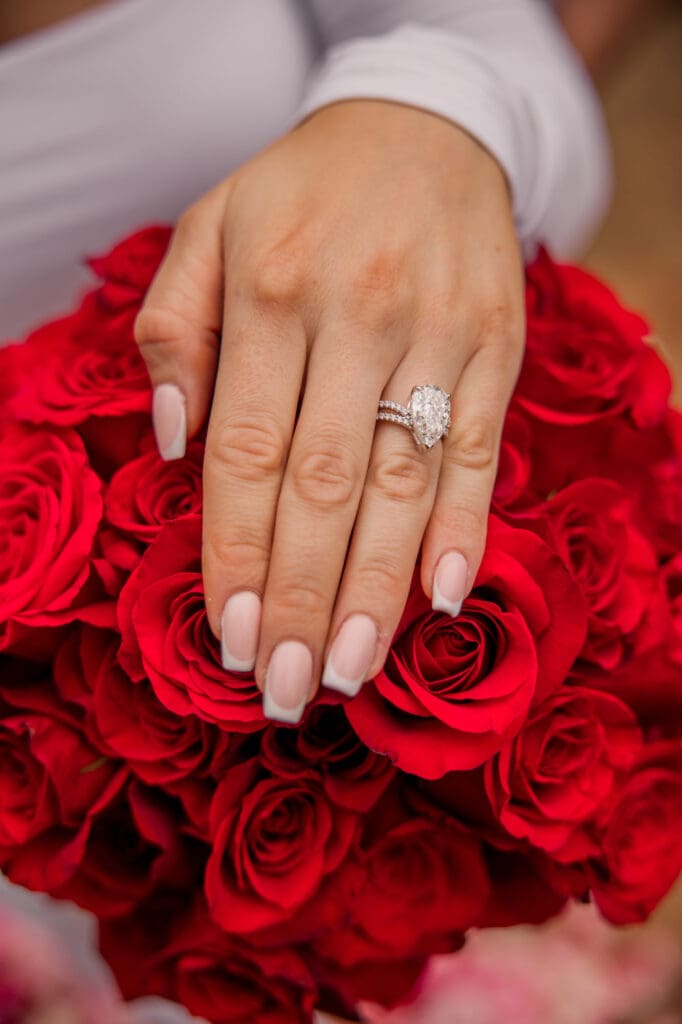engagement ring on red rose bouquet 
